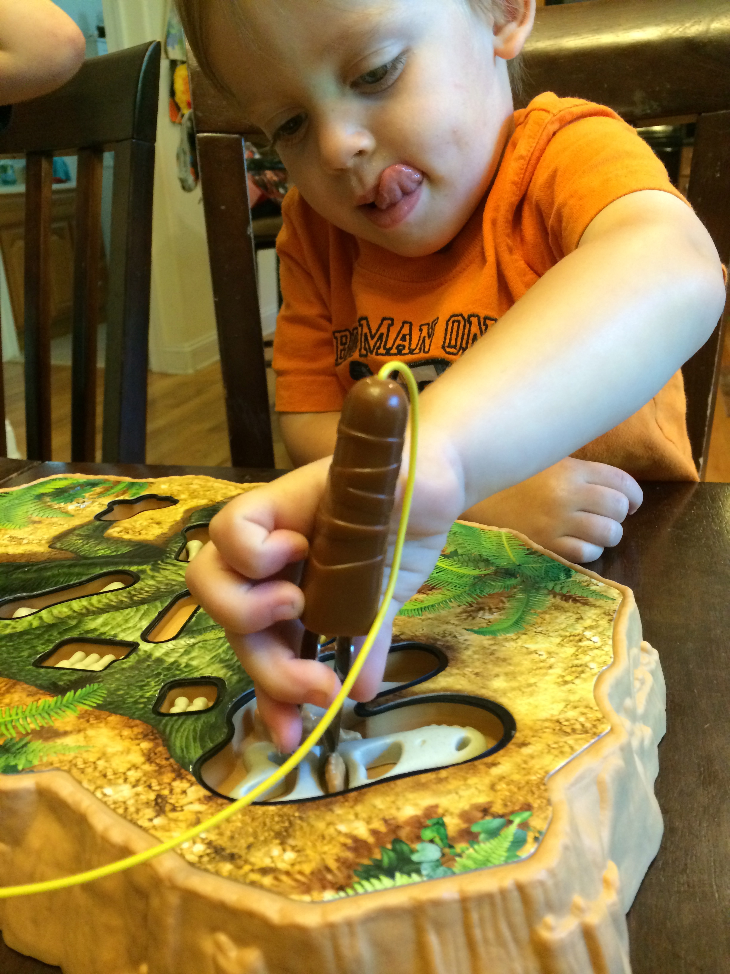 T-REXcavator helps kids develop valuable developmental skills such fine motor strength, problem solving and patience! As you can see in this picture, determination is also needed!