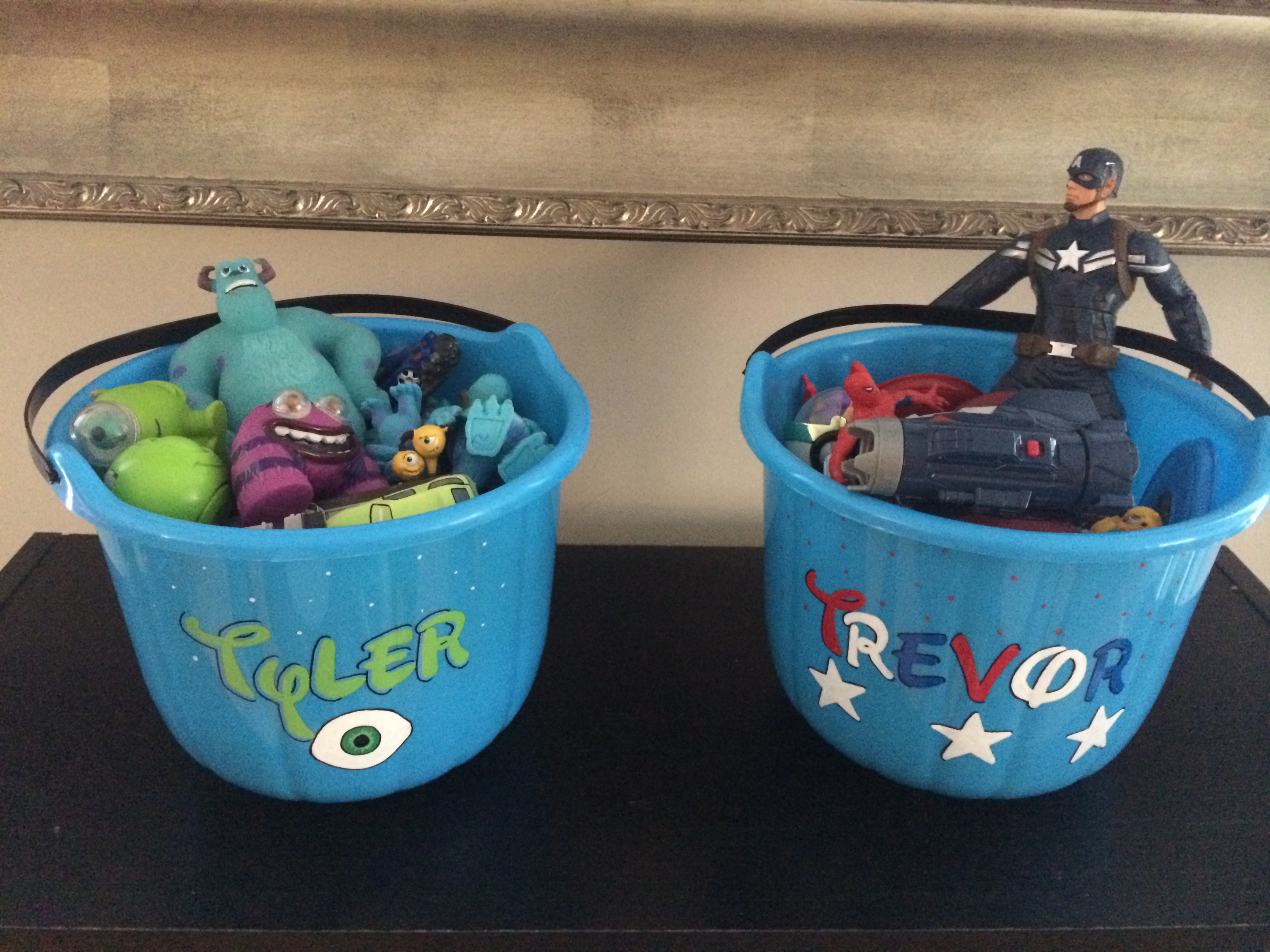 We are using our buckets to story Disney and superhero toys!